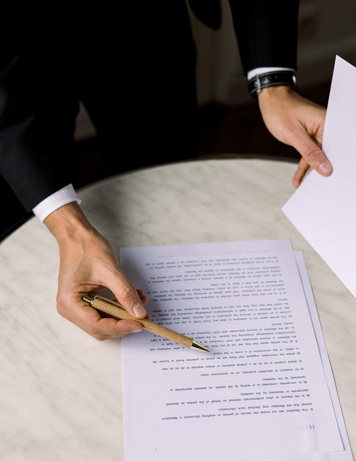 Party signing a mediation agreement after a succefuls conflict management session for a workplace dispute.